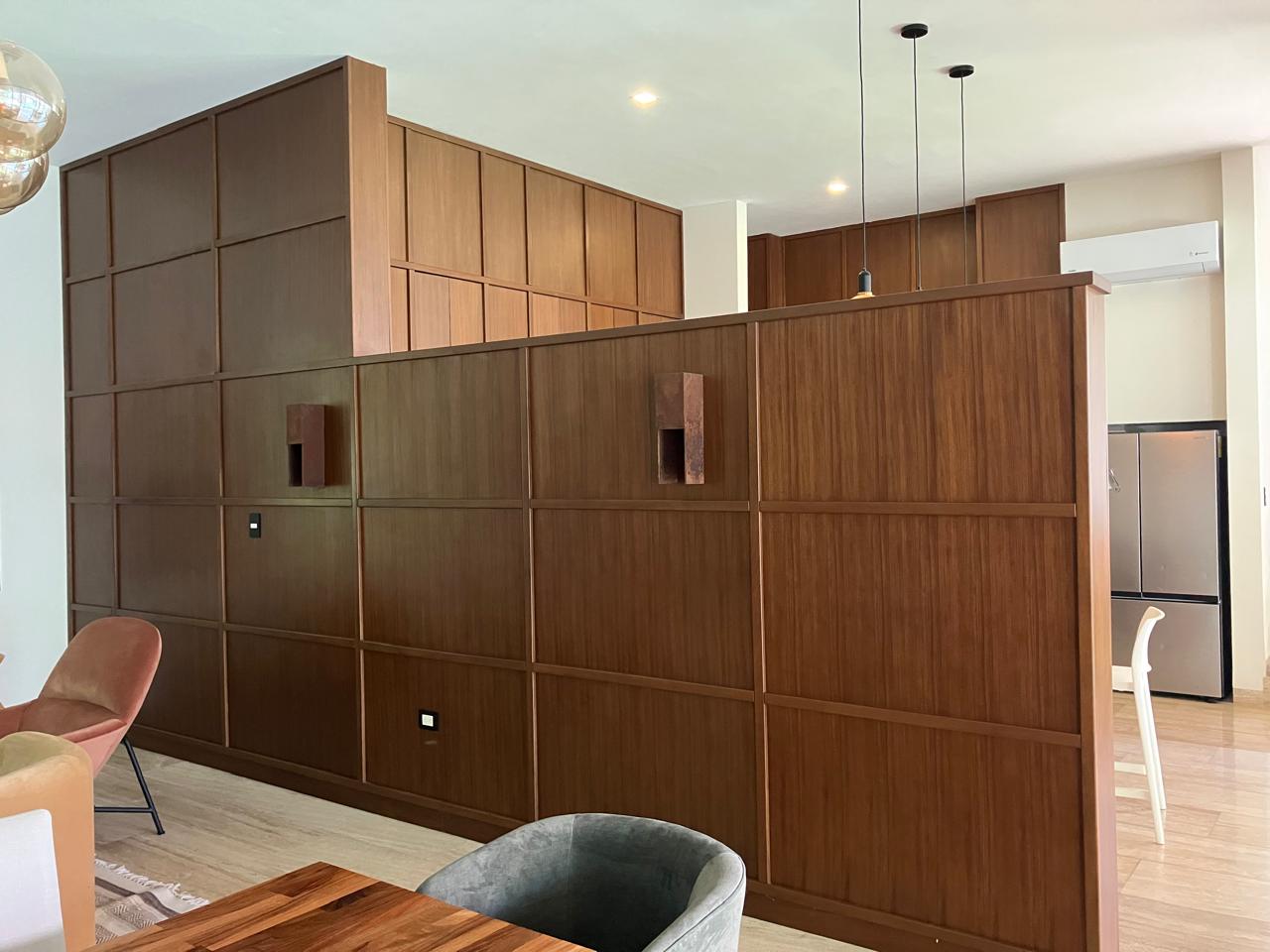 Muro de madera con paneles y nichos en sala residencial
